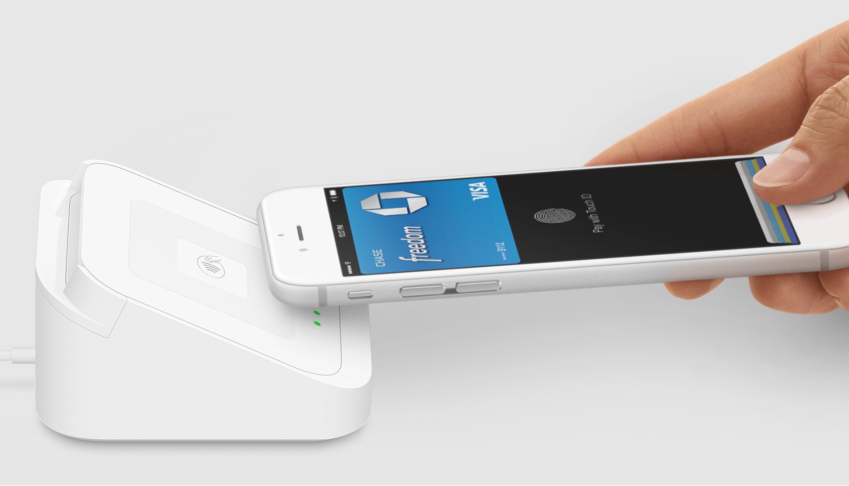 Hand holding a phone showing Apple Pay with a Square reader