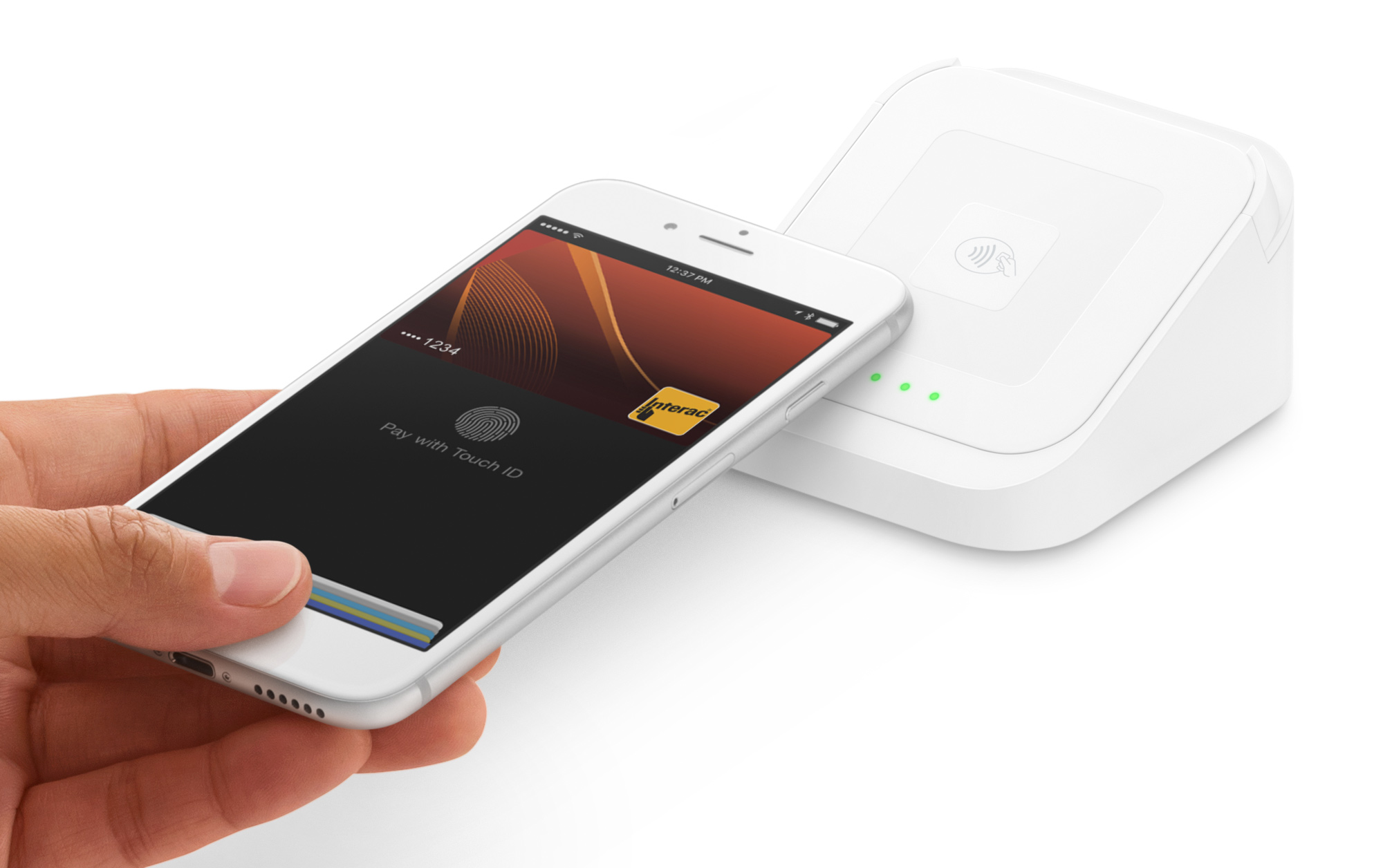 Image of hand holding iPhone paying with Apple Pay near Square contactless and chip reader